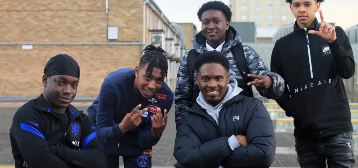 Amani Simpson with a group of young black boys