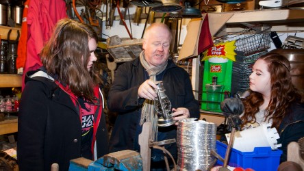 Props master showing students an old lantern during a Screenworks session