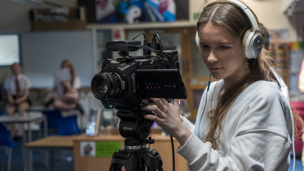 Teenage girl operating a camera