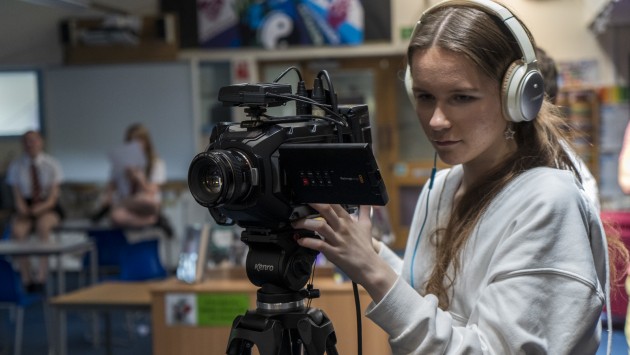 Teenage girl operating a camera
