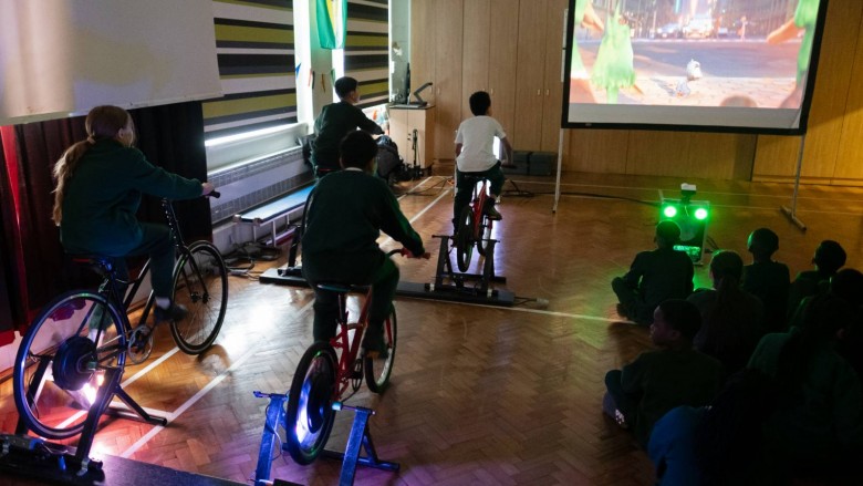 Children power their own Into Film Festival screening using bicycles.