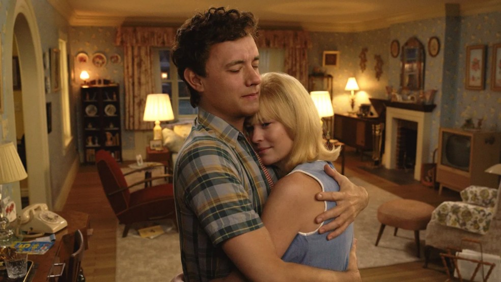 A young man and a young woman hug in a living room