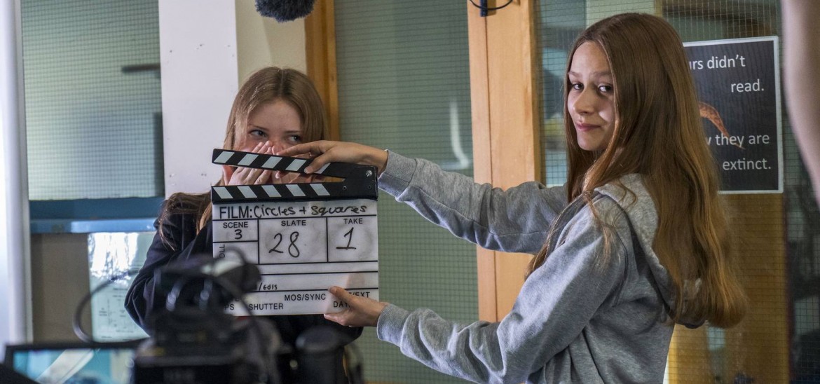 Filmmaking - two girls with clapperboard.