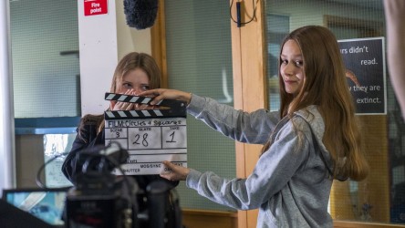 Filmmaking - two girls with clapperboard.