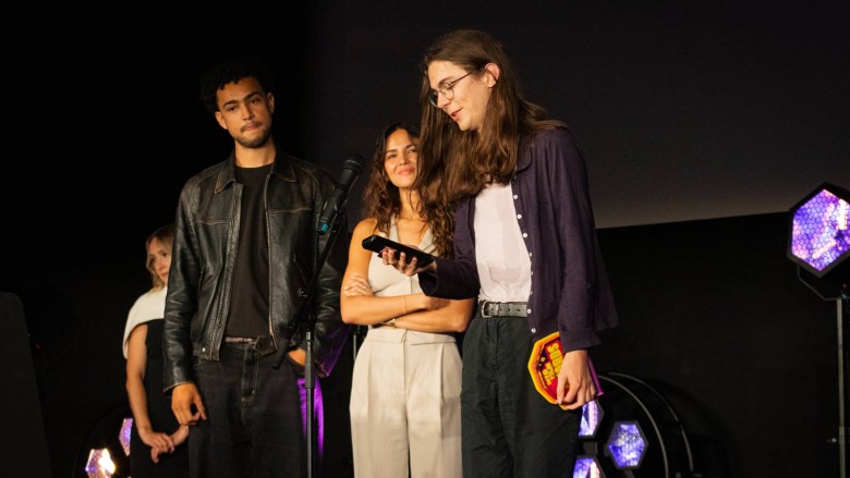 Best Story winner Ben Melocha gives a speech on stage