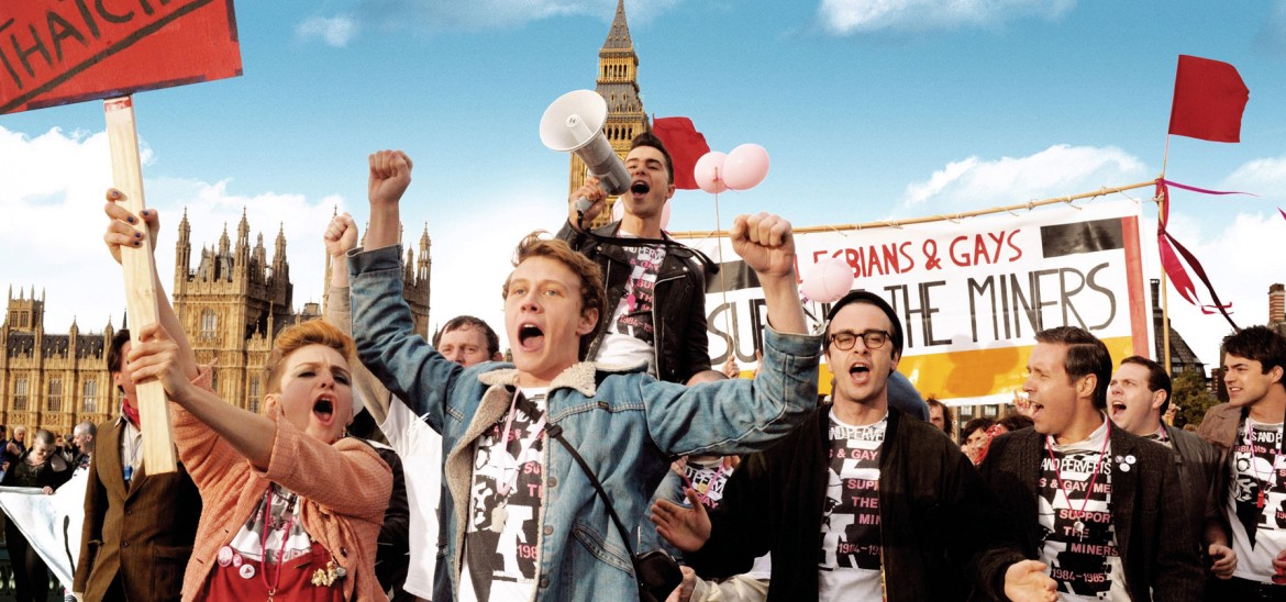A group of people marching and shouting in London with placards.