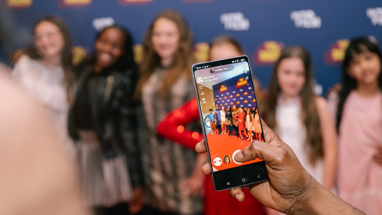 Someone takes a photo of a group of young nominees at the Into Film Awards