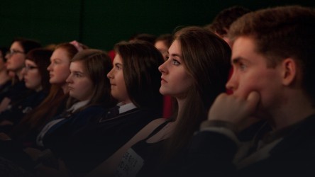Young people watching film in cinema