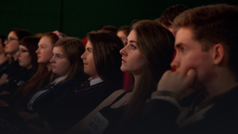 Young people watching film in cinema