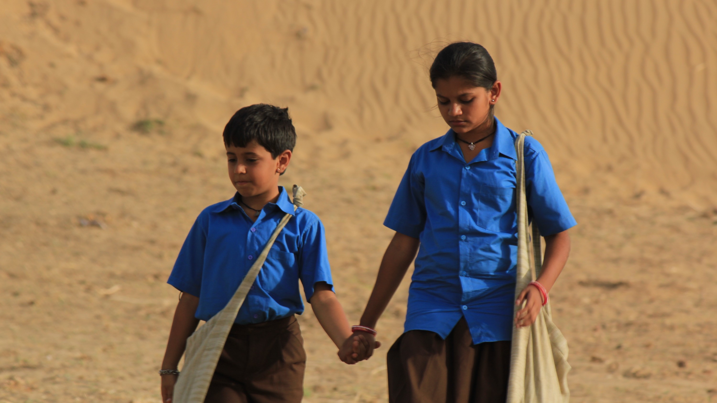 This image from Dhanak shows the characters holding hands in uniform.