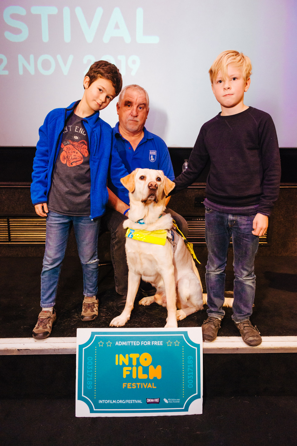 Guide Dogs' Dave Kent with two young attendees and his guide dog Chad