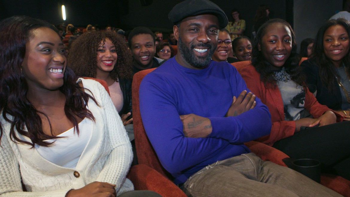 Idris Elba in cinema with young people