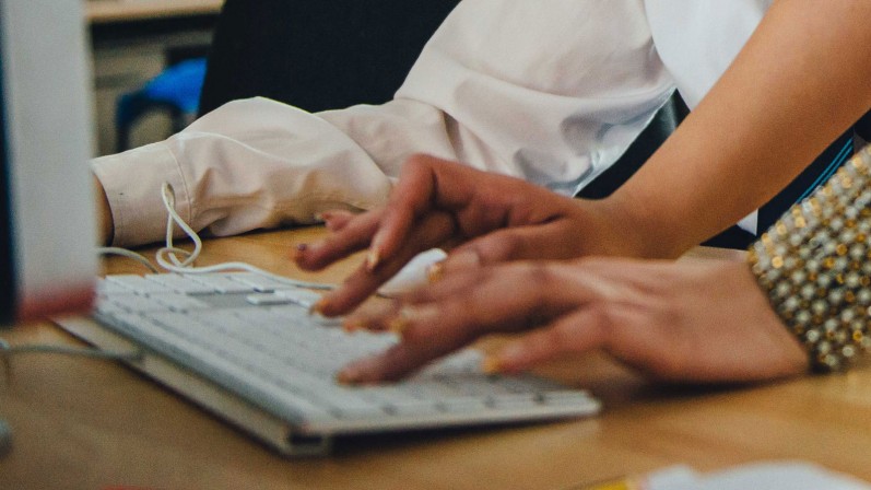 Hands typing on a keyboard