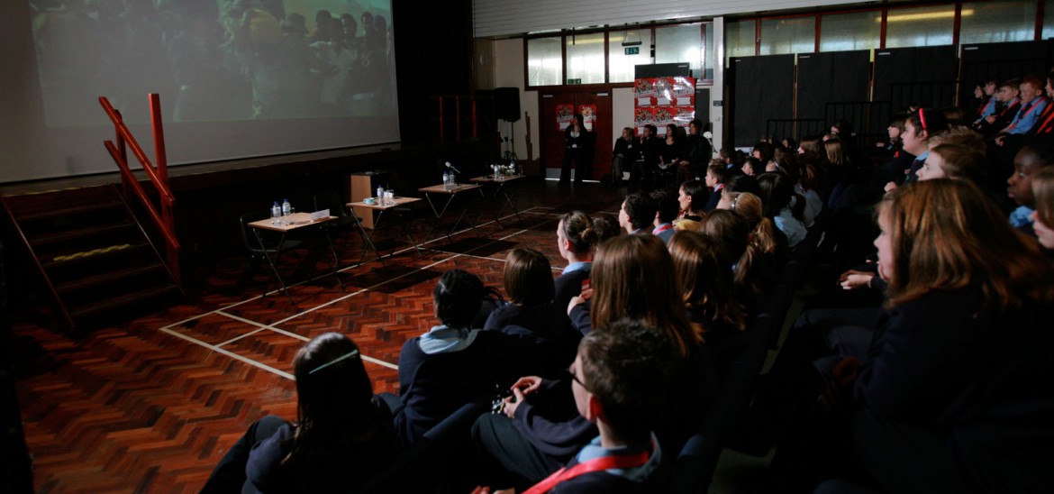 Group of children watching films in a sports hall