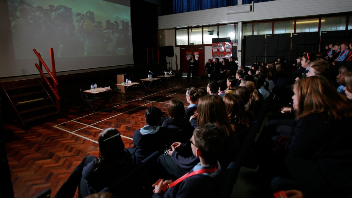 Group of children watching films in a sports hall