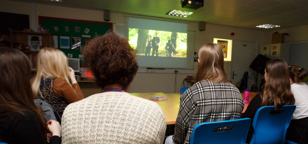 5 people in film club watching screen