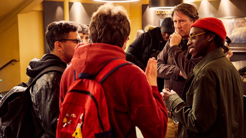 Young people chatting to Joe Cornish and Michael Ajao