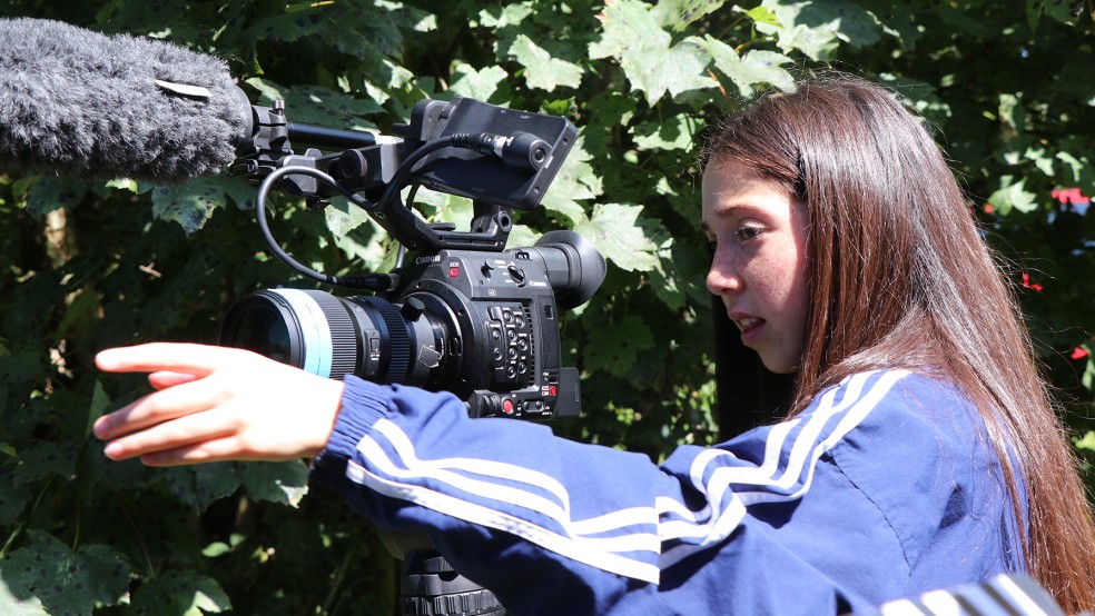 Eden Quine-Taylor operating a camera