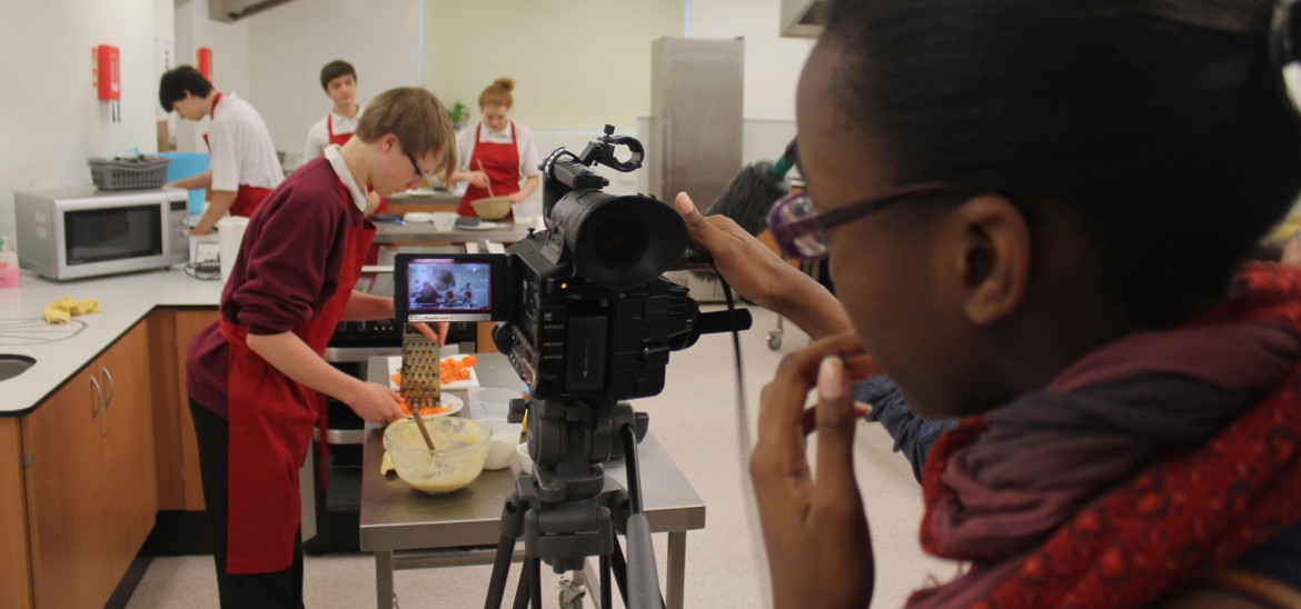 Secondary students using filmmaking equipment