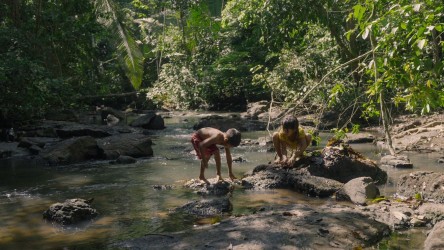 Two children play in a river.