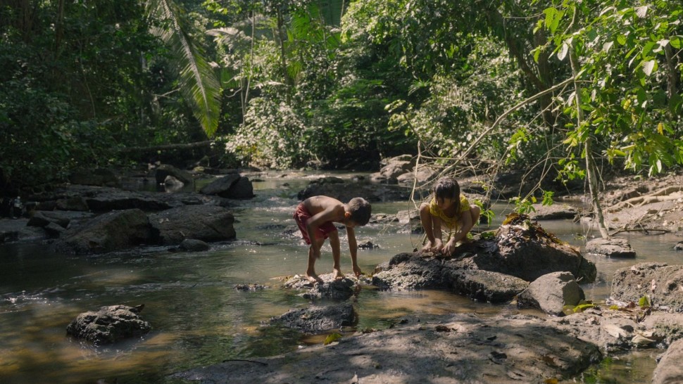 Two children play in a river.