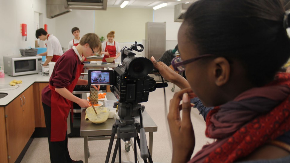 Secondary students using filmmaking equipment