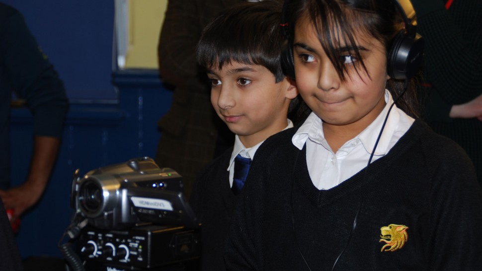 A picture of children using filmmaking equipment